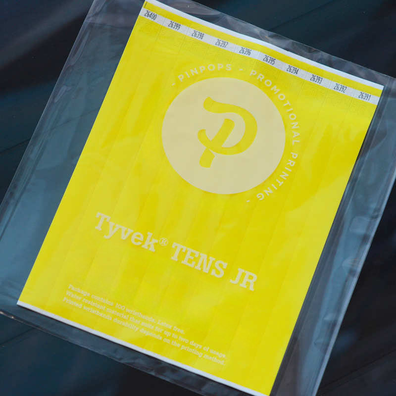 Yellow Tyvek Tens wristband with a permanent closure. Prenumbered in sequential order.