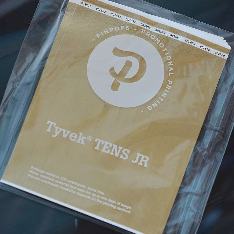 Gold metallic Tyvek Tens wristband with a permanent closure. Prenumbered in sequential order.