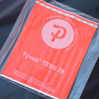 Neon Orange Tyvek Tens wristband with a permanent closure. Prenumbered in sequential order.